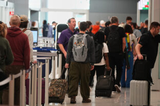 Travellers queue up at west security checkpoint in denver airport