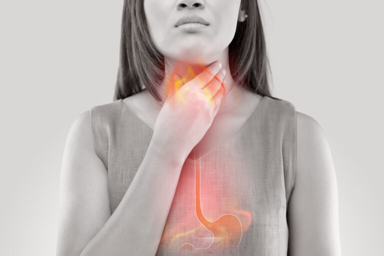 Woman Suffering From Acid Reflux Or Heartburn Isolated On White