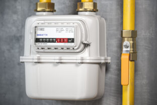 Natural gas meter with tubes on the wall.