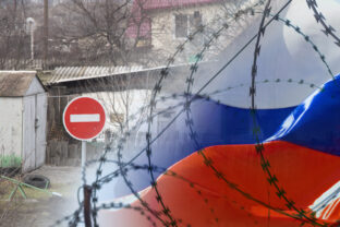 Road sign traffic is prohibited on the background of private houses and the flag of Russia behind barbed wire. Isolation of the Russian Federation from the world, sanctions