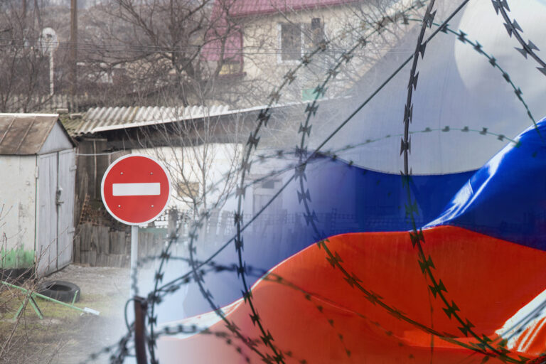 Road sign traffic is prohibited on the background of private houses and the flag of Russia behind barbed wire. Isolation of the Russian Federation from the world, sanctions