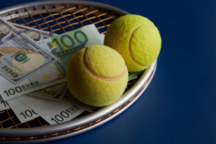 Two yellow tennis balls lying on a racket next to money, blue background, close up, winnings, prize money in tennis, sports betting.