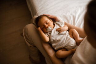 Baby lying on mother hands