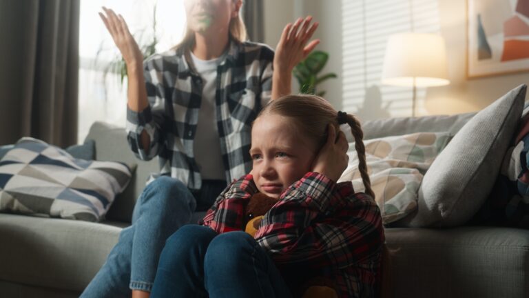 Family domestic violence trouble frustrated little child girl kid daughter close ears with hands at home with angry furious mother woman babysitter scold talking argument conflict psychology problem