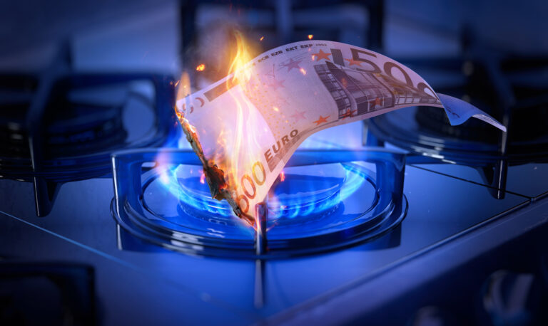 Euro banknote burning over a gas stove flame symbolizing energy crisis