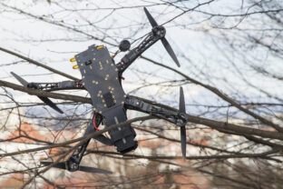 Drone quadcopter crashed on tree in city park