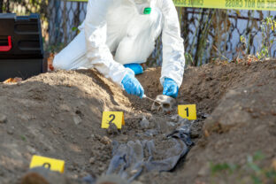 War crime investigation. Forensic science specialist at work.