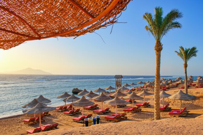 Idylic beach with palms and sun umbrelas, Red Sea, Egypt