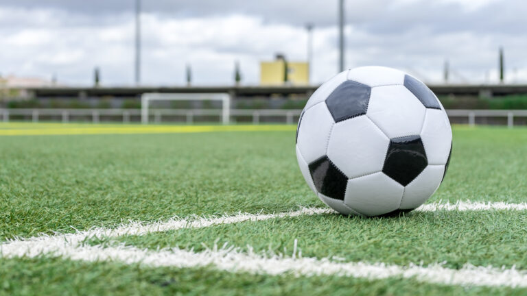 SOCCER BALL ON THE GRASS IN THE FOOTBALL FIELD.