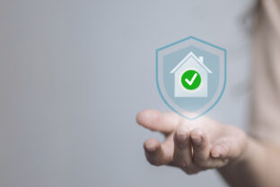 Home Security Shield with Check Mark in Hand, Insurance Approval and Protection