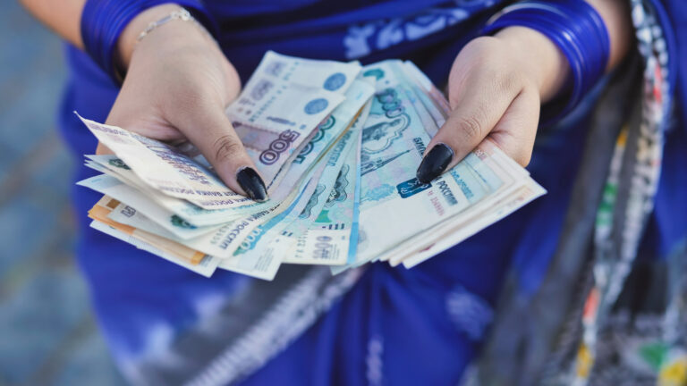 Person holding Russian Ruble banknotes for payment