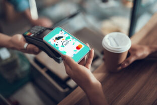 Hand of young lady placing smartphone on credit card payment machine