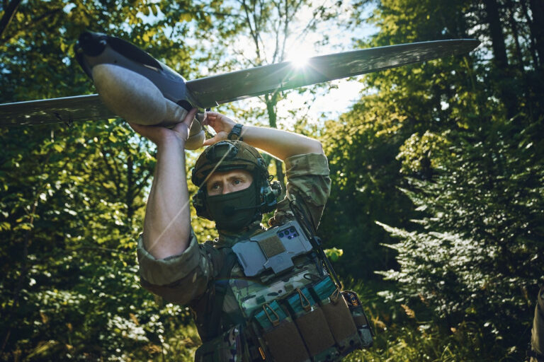 Drones_soldier_holding_pre launch_drone_in_forest.jpg
