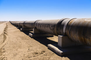 Large steel pipe in a desert