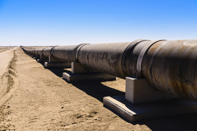 Large steel pipe in a desert