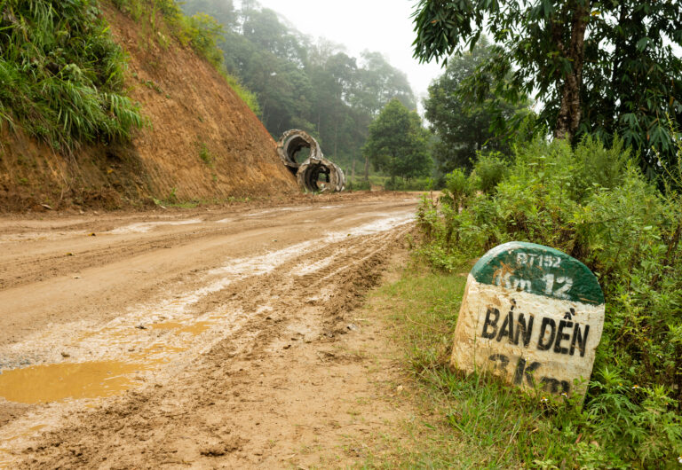 Road signs with mud and puddles