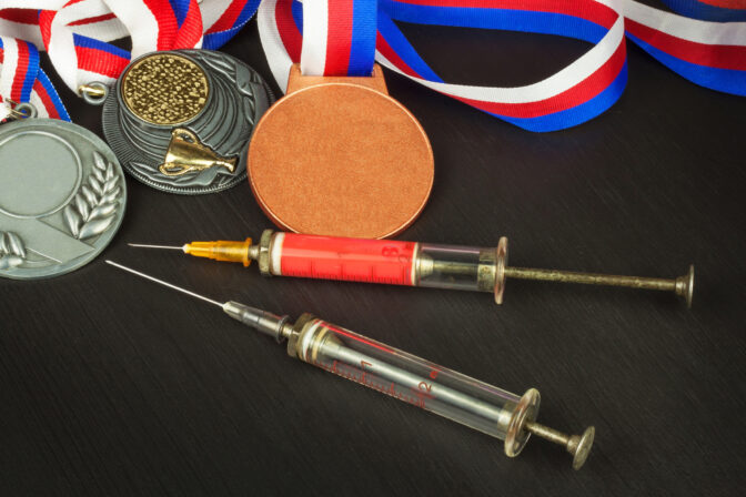 Syringe and medals. Doping in sport. Doping athletes.