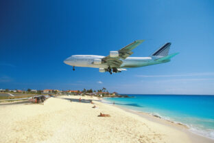 Plane coming in for landing on Maho Bay Beach, Saint Martin, Caribbean