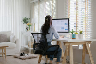 Smart Gen Z tech talent workforce typing SEO sale report on desktop PC happy work easy relax at home office. Remote WFH reskill upskill job MBA study of young people asia woman examine big data graph.