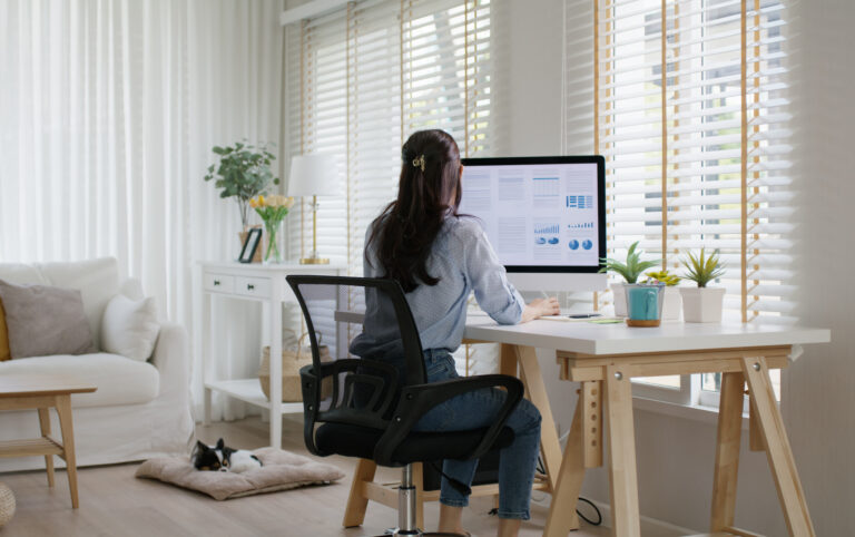 Smart Gen Z tech talent workforce typing SEO sale report on desktop PC happy work easy relax at home office. Remote WFH reskill upskill job MBA study of young people asia woman examine big data graph.