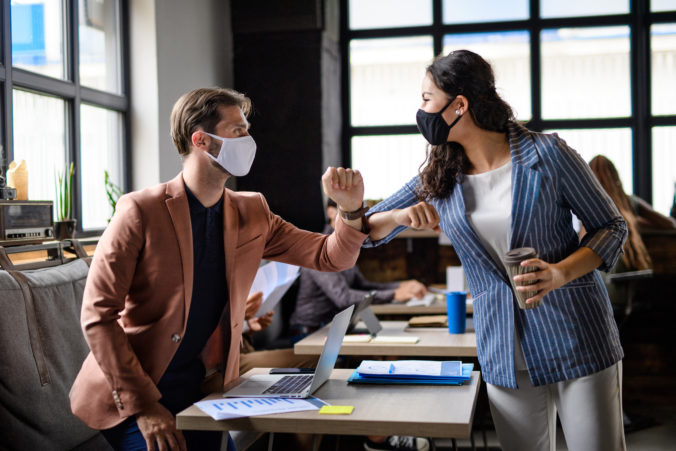 95388_business people with face masks greeting indoors i rmdemtr_edit 676x451.jpg