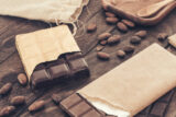 110585_chocolate bar with cocoa beans wooden table 676x451.jpg