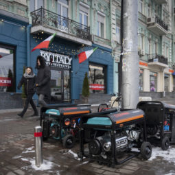 People pass by working generators during a power outage in Kyiv, Ukraine, Monday, Feb. 6, 2023. Russia has been bombing Ukrainian power grids for months, which caused rolling and emergency blackouts across the country