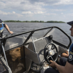 Police officers patrol area of Kakhovka reservoir on Dnipro river near Lysohirka, Ukraine, Thursday, May 18, 2023. Damage that has gone unrepaired for months at a Russian-occupied dam is causing dangerously high water levels along a reservoir in southern Ukraine