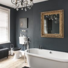 Black bathroom gold mirror and delicate chandelier in dark bathroom.jpg