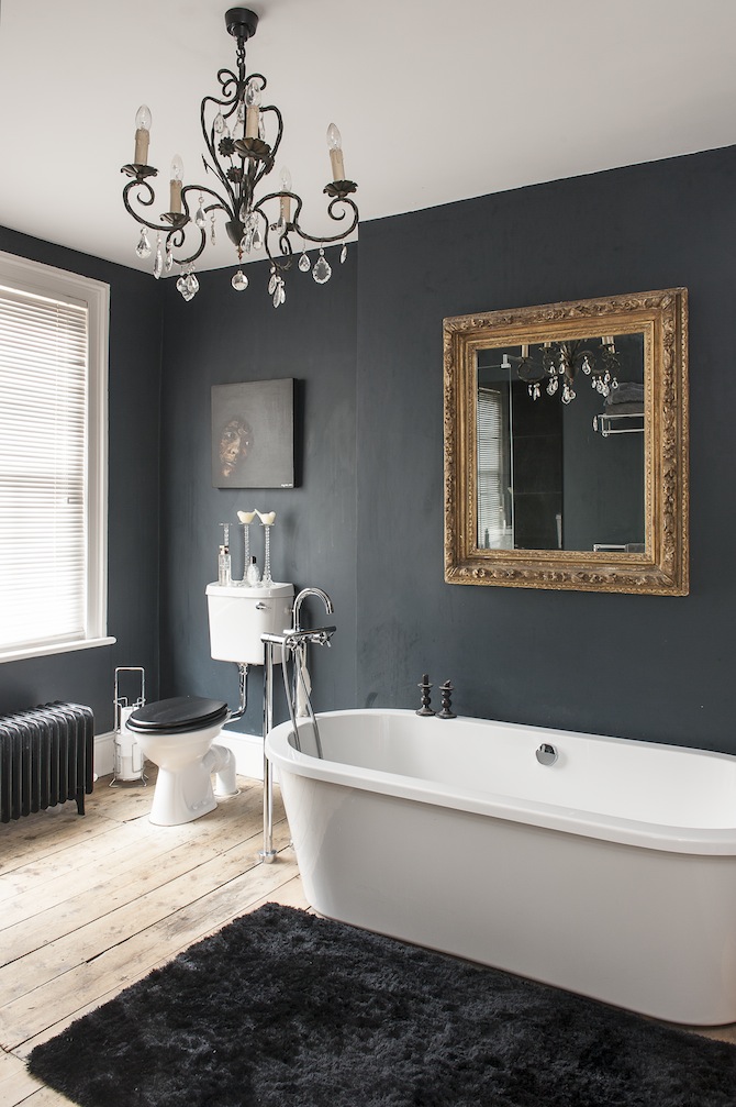 Black bathroom gold mirror and delicate chandelier in dark bathroom.jpg