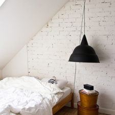 Black lamp in white bedroom with small table.jpg