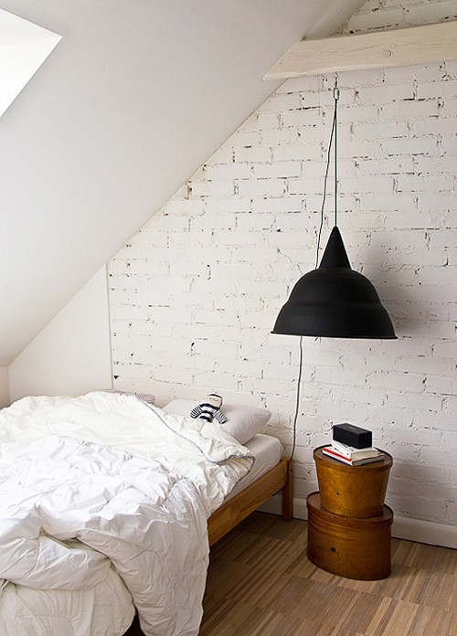 Black lamp in white bedroom with small table.jpg