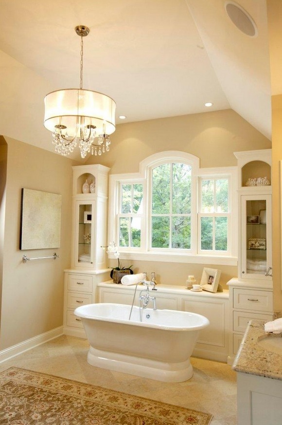 Traditional bathroom in miami with a freestanding tub and beautiful window surrounded by cabinets.png