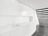 White minimalist kitchen with modern lighting.jpg