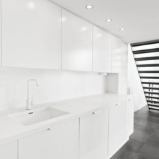 White minimalist kitchen with modern lighting.jpg