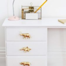 Post_furniture white stained solid wood study table having gold animals pull handle using black metal legs with beveled countertop placed on brown wooden plank floor diy drawer pulls 744x1116.jpg