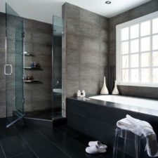 Adorable bathroom design with black wall paint color and black ceramic floor tiles and modern white bathtub idea and glass windows and hidden ceiling lights also glass doors.jpg