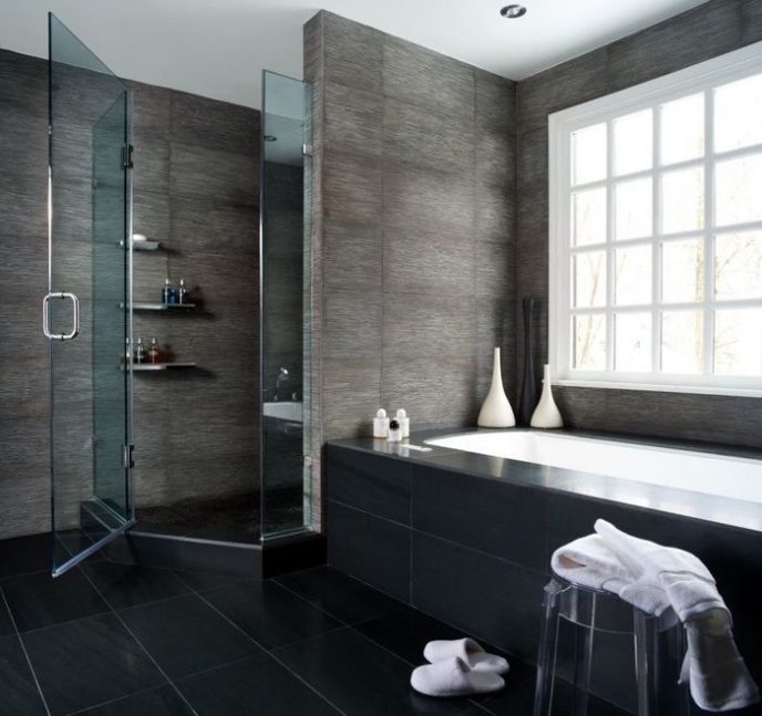 Adorable bathroom design with black wall paint color and black ceramic floor tiles and modern white bathtub idea and glass windows and hidden ceiling lights also glass doors.jpg