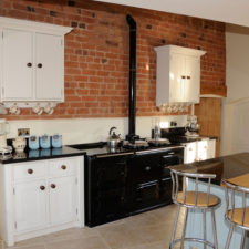 Post_pleasant white cabinet and black gas stove also red brick wall accent as brick kitchen idea1.jpg