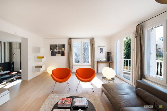 Post_an exciting hall design with fancy orange chairs and pretty white table decor with modern grey leather sofa and white floating shelf and cream fur rug 1.jpg