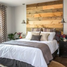 Post_contemporary bedroom with warm accent wood headboard coupled with modern grey white bedding and unique side lamp also bold pattern drapes.jpg