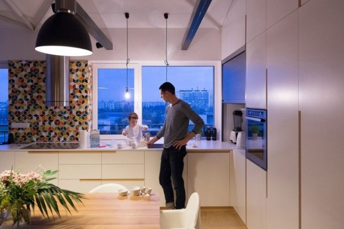 Post_white kitchen cabinet and kitchen countertop_wooden dining table with white chair_simple black pendant lamp_white wall paint_large glass windows.jpg