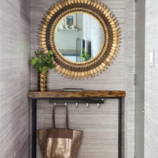 Post_condo entry with gray grasscloth gold sunburst mirror walnut live edge shelf and turkish rug petite entry 973x1460.jpg