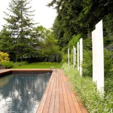 Post_powder coated white steel and back lit translucent panels bring privacy to the backyard.jpg