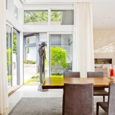 Post_sculptural addition in the corner and glass walls add elegance to the contemporary dining room.jpg