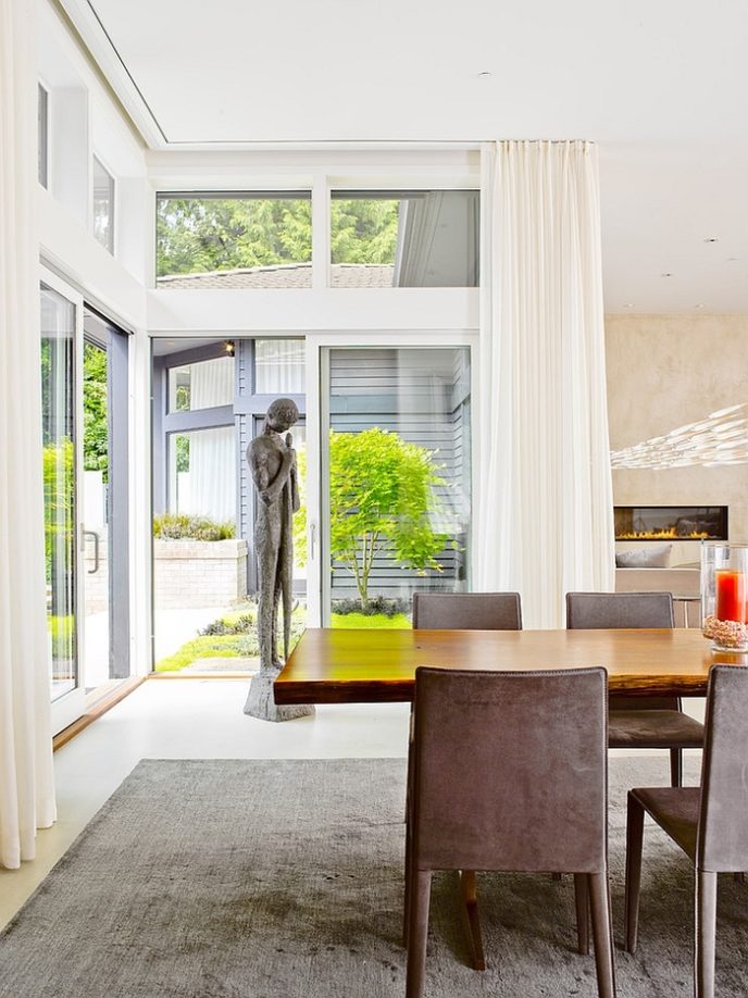 Post_sculptural addition in the corner and glass walls add elegance to the contemporary dining room.jpg