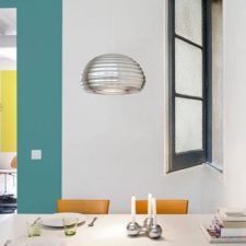 Post_bright metallic pendant and window enliven the small dining space.jpg