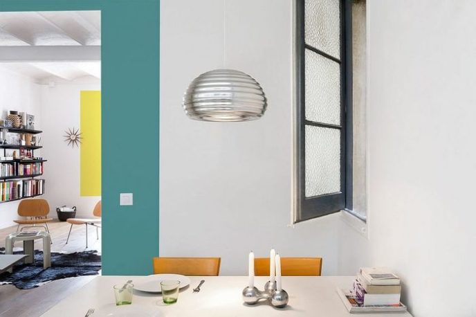 Post_bright metallic pendant and window enliven the small dining space.jpg