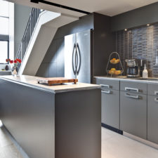 Post_modern understair kitchen design with grey cabinets and kitchen island finish granite countertop.jpg