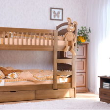 Post_chic wooden bunk bed with curved headboard and foot board on white rug plus tall cest of drawers plus elephant decor.jpg